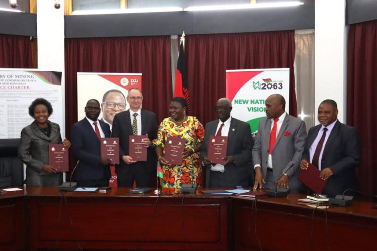 Ministers of Mining, Monica Chang'anamuno, Finance Simplex Chithyola Banda and Representative of the mining companies during the signing ceremony of MDAs in Lilongwe